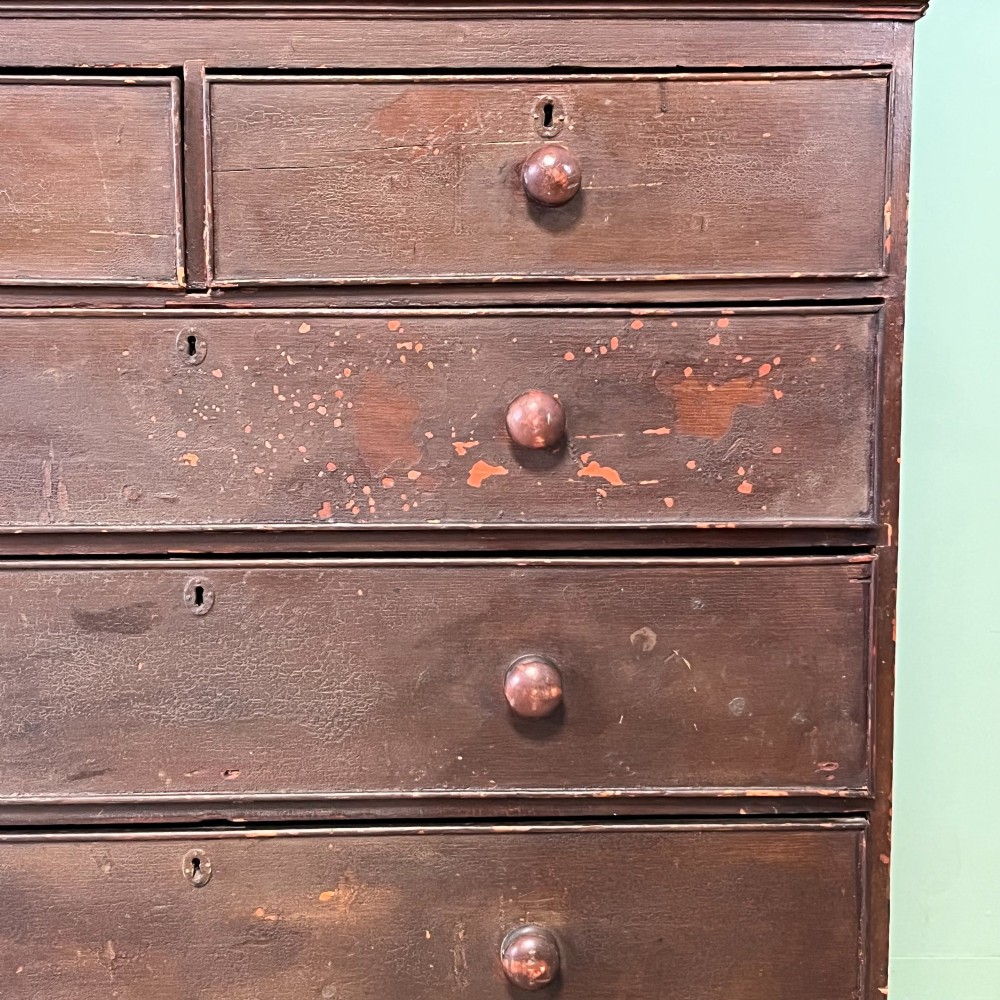 An early 19th-century Irish painted pine press cupboard with two panelled upper doors over a base section containing five drawers. View V
