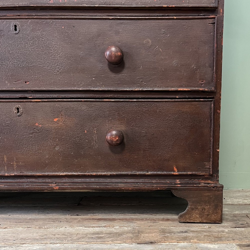 An early 19th-century Irish painted pine press cupboard with two panelled upper doors over a base section containing five drawers. View VI