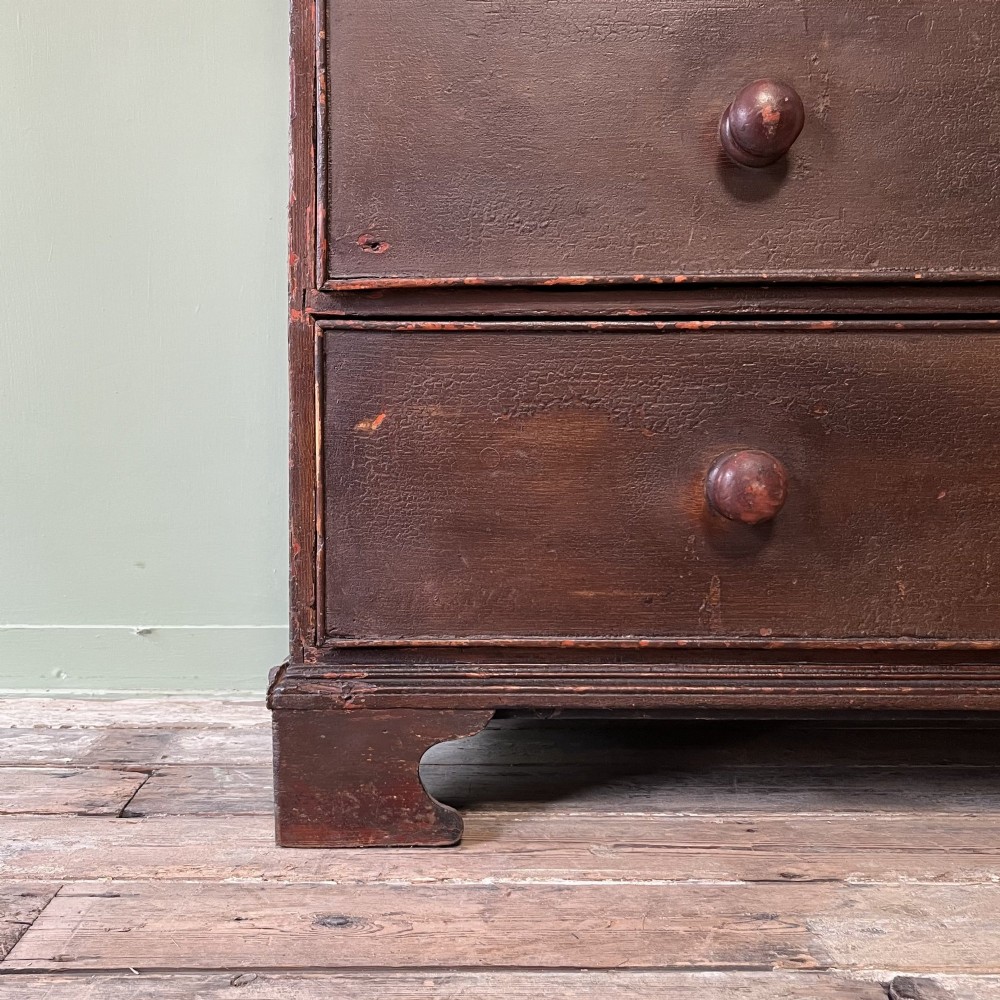 An early 19th-century Irish painted pine press cupboard with two panelled upper doors over a base section containing five drawers. View VII