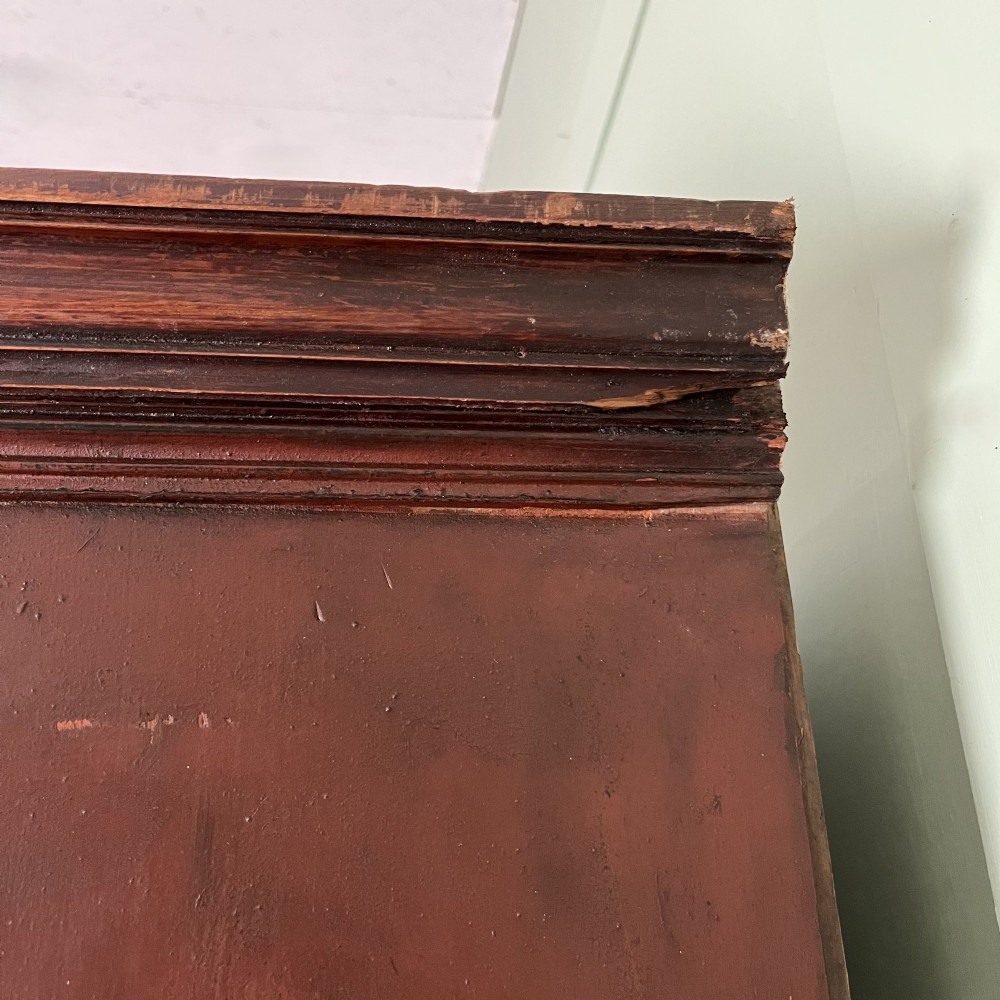 An early 19th-century Irish painted pine press cupboard with two panelled upper doors over a base section containing five drawers. View XI