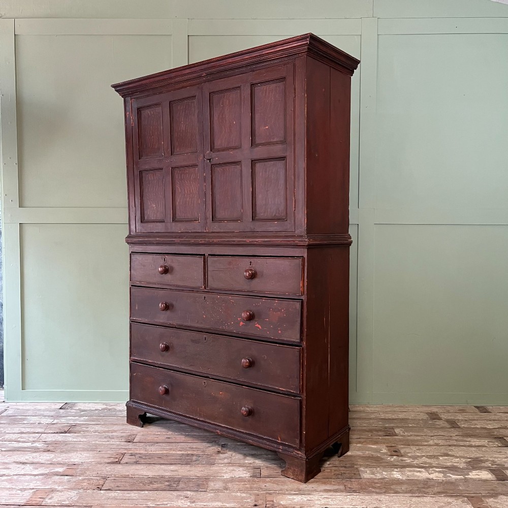 An early 19th-century Irish painted pine press cupboard with two panelled upper doors over a base section containing five drawers. View XIII