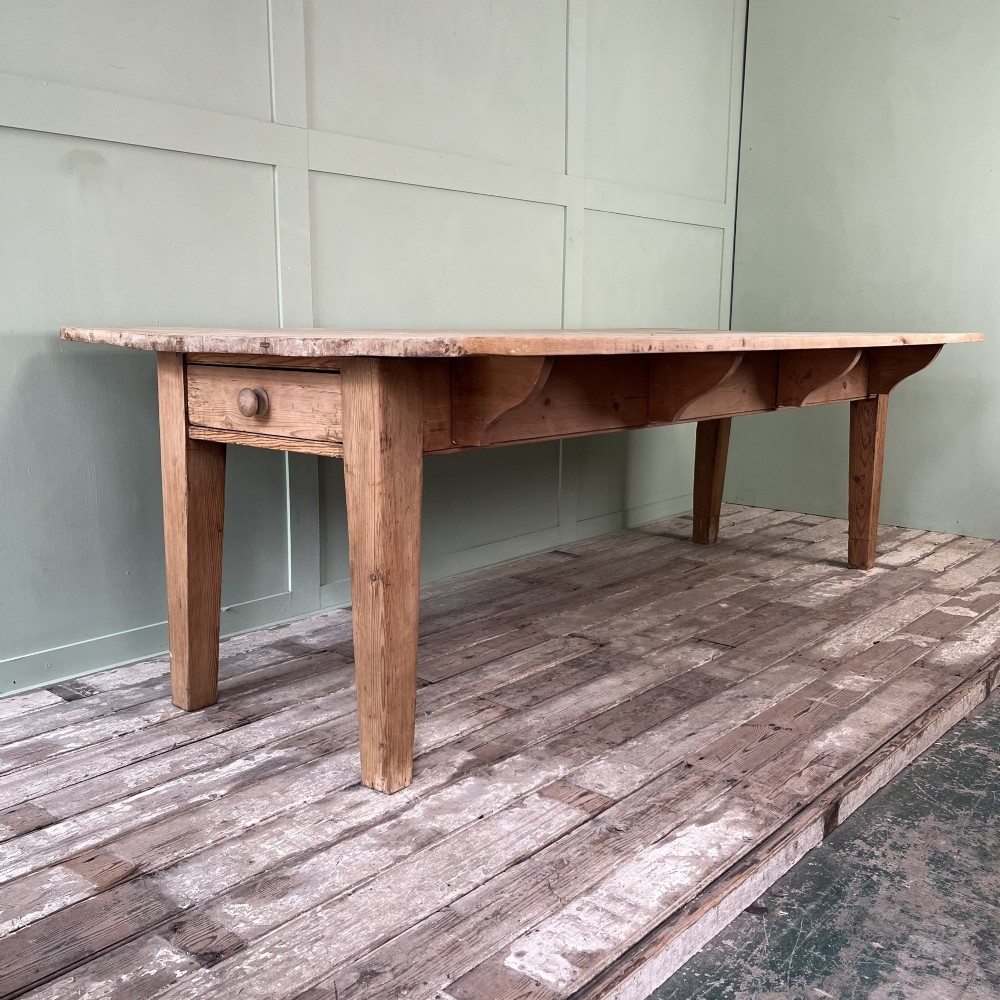 A large Victorian pine farmhouse dining table featuring a multi-plank top, deep apron with supporting brackets, and four straight tapered legs. View II