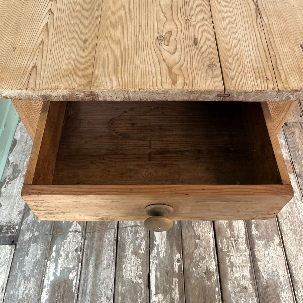 A large Victorian pine farmhouse dining table featuring a multi-plank top, deep apron with supporting brackets, and four straight tapered legs. View VI