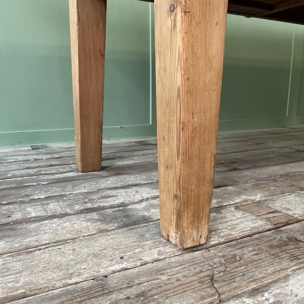 A large Victorian pine farmhouse dining table featuring a multi-plank top, deep apron with supporting brackets, and four straight tapered legs. View VIII