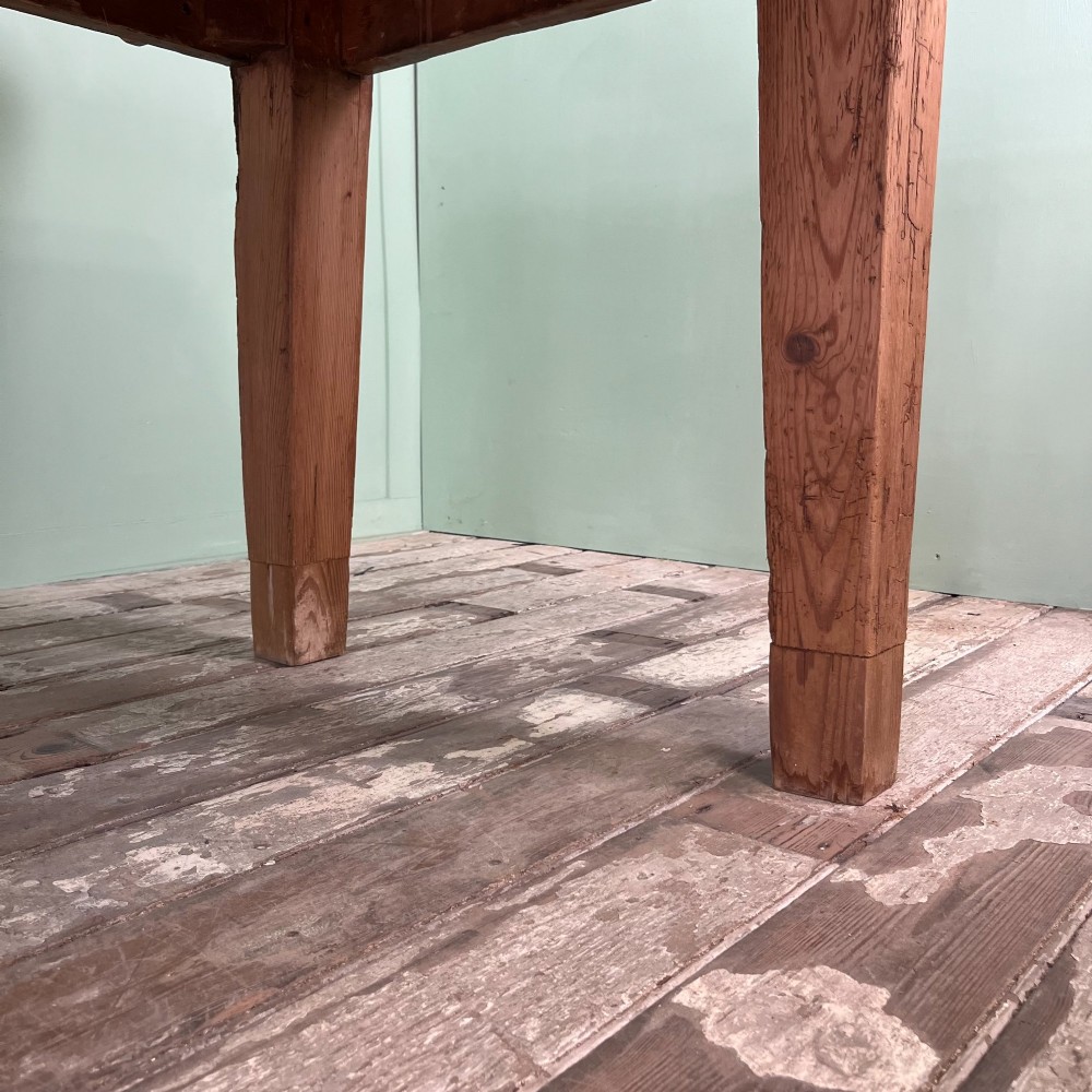 A large Victorian pine farmhouse dining table featuring a multi-plank top, deep apron with supporting brackets, and four straight tapered legs. View IX