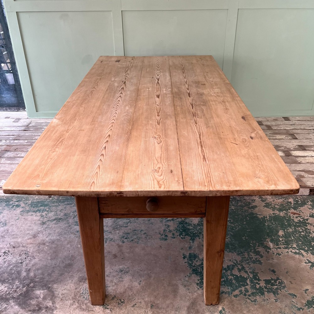 A large Victorian pine farmhouse dining table featuring a multi-plank top, deep apron with supporting brackets, and four straight tapered legs. View X