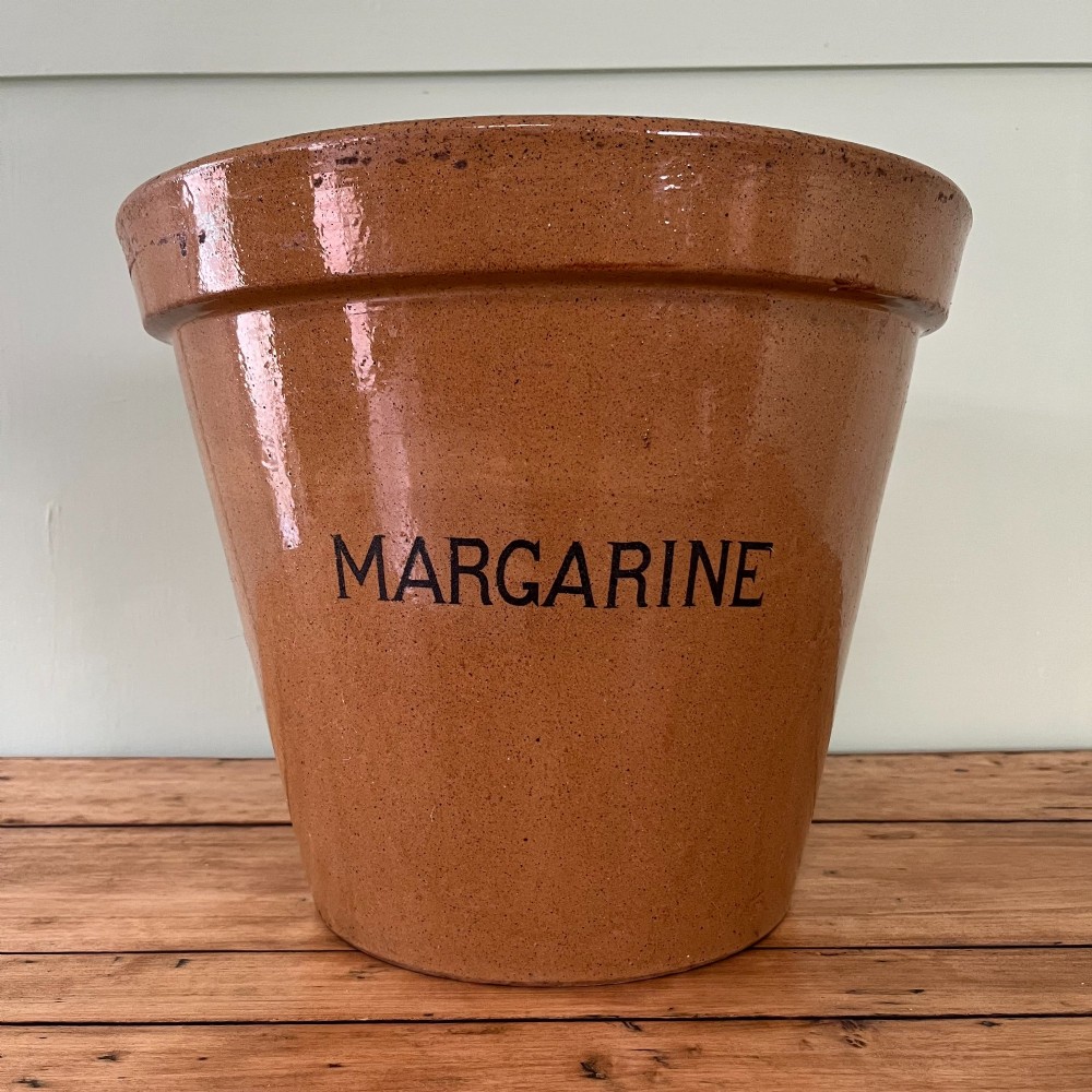 A large tan glazed stoneware bowl with a flared rim and the word MARGARINE stencilled in black lettering across the front. View II