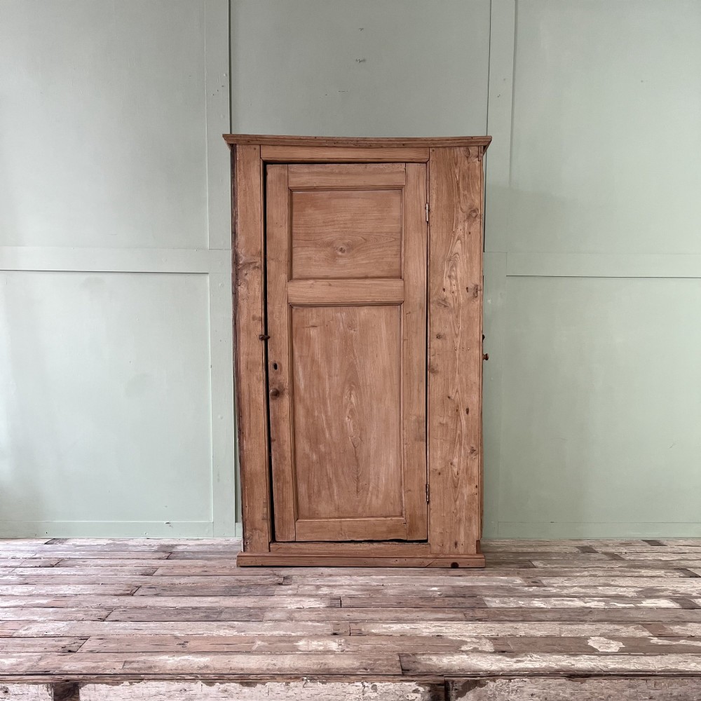 An 18th-century Welsh standing elm food cupboard featuring twin panelled doors open to reveal multiple interior shelves set against a pale background. View II