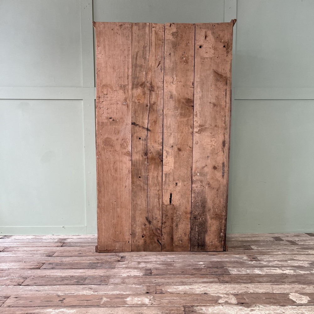 An 18th-century Welsh standing elm food cupboard featuring twin panelled doors open to reveal multiple interior shelves set against a pale background. View XIII