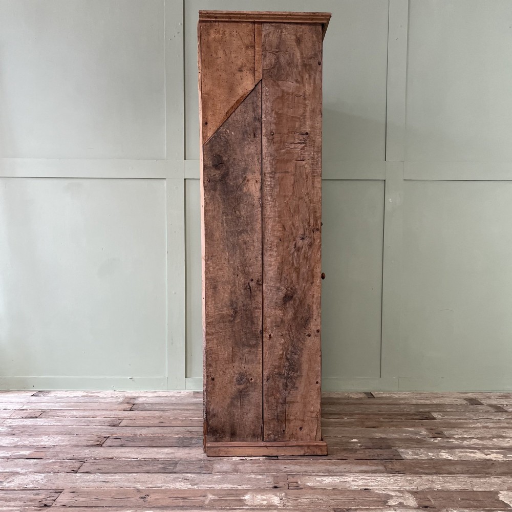 An 18th-century Welsh standing elm food cupboard featuring twin panelled doors open to reveal multiple interior shelves set against a pale background. View XIV