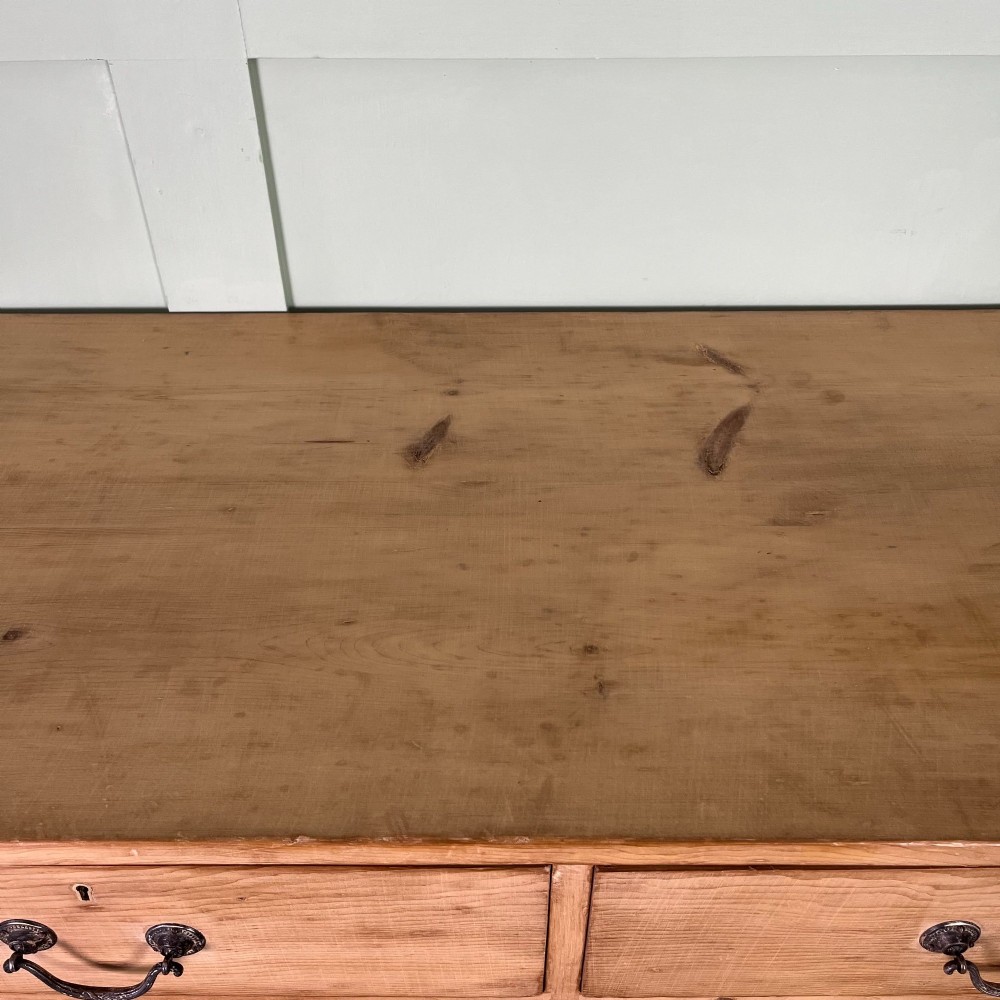 A Victorian natural pine chest of drawers featuring two short drawers over three long drawers with metal drop handles. View XI