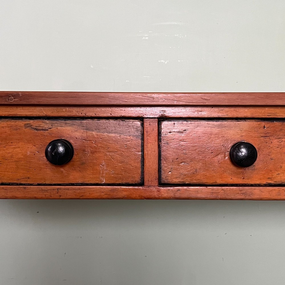 An antique pine hall table featuring two drawers with dark turned handles and slender turned legs. View VIII