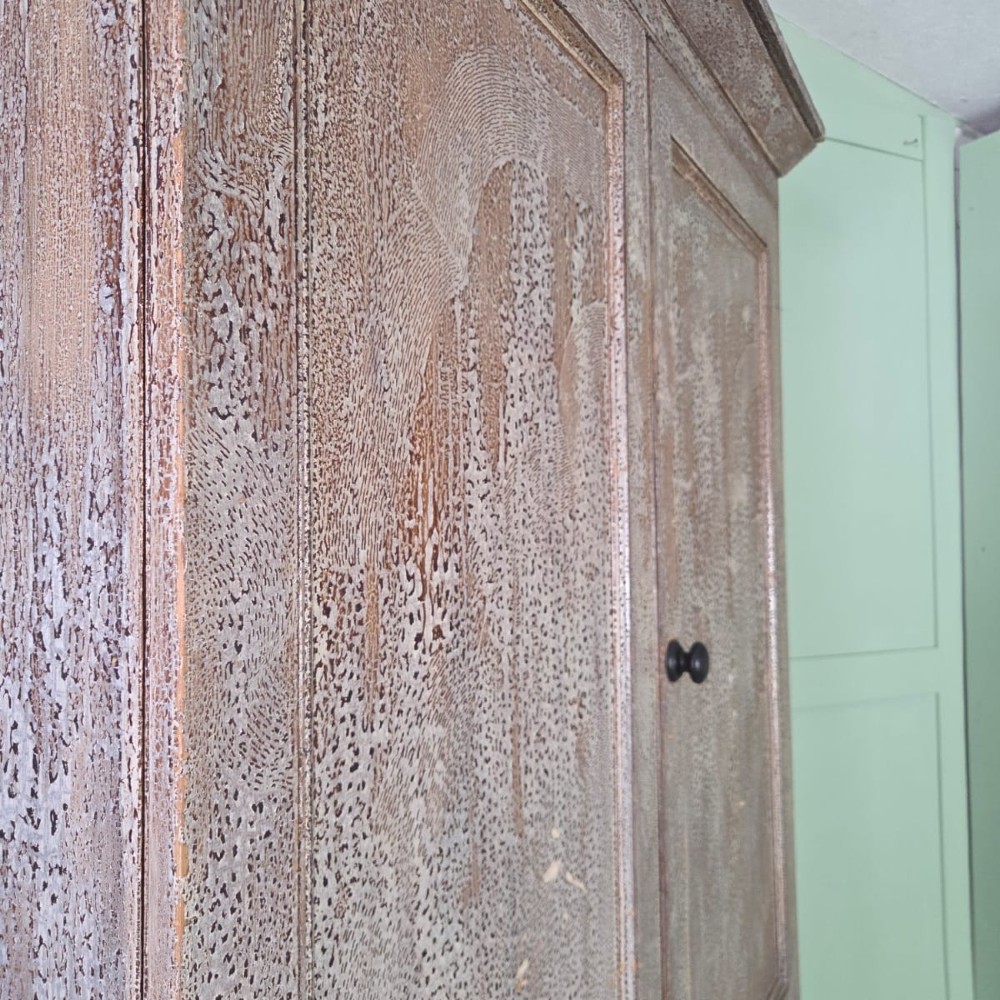 A tall late Georgian painted pine housekeepers cupboard featuring panelled upper doors and three lower drawers on turned feet. View V