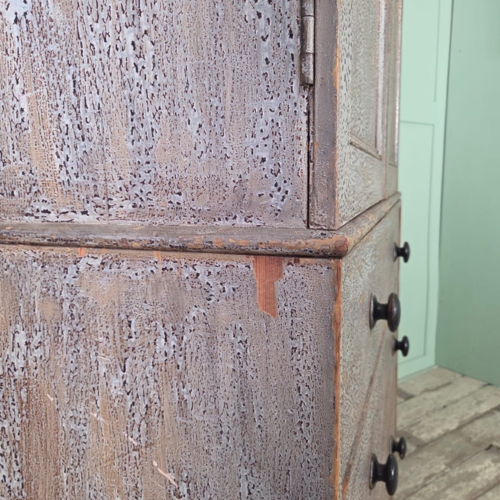 A tall late Georgian painted pine housekeepers cupboard featuring panelled upper doors and three lower drawers on turned feet. View IX