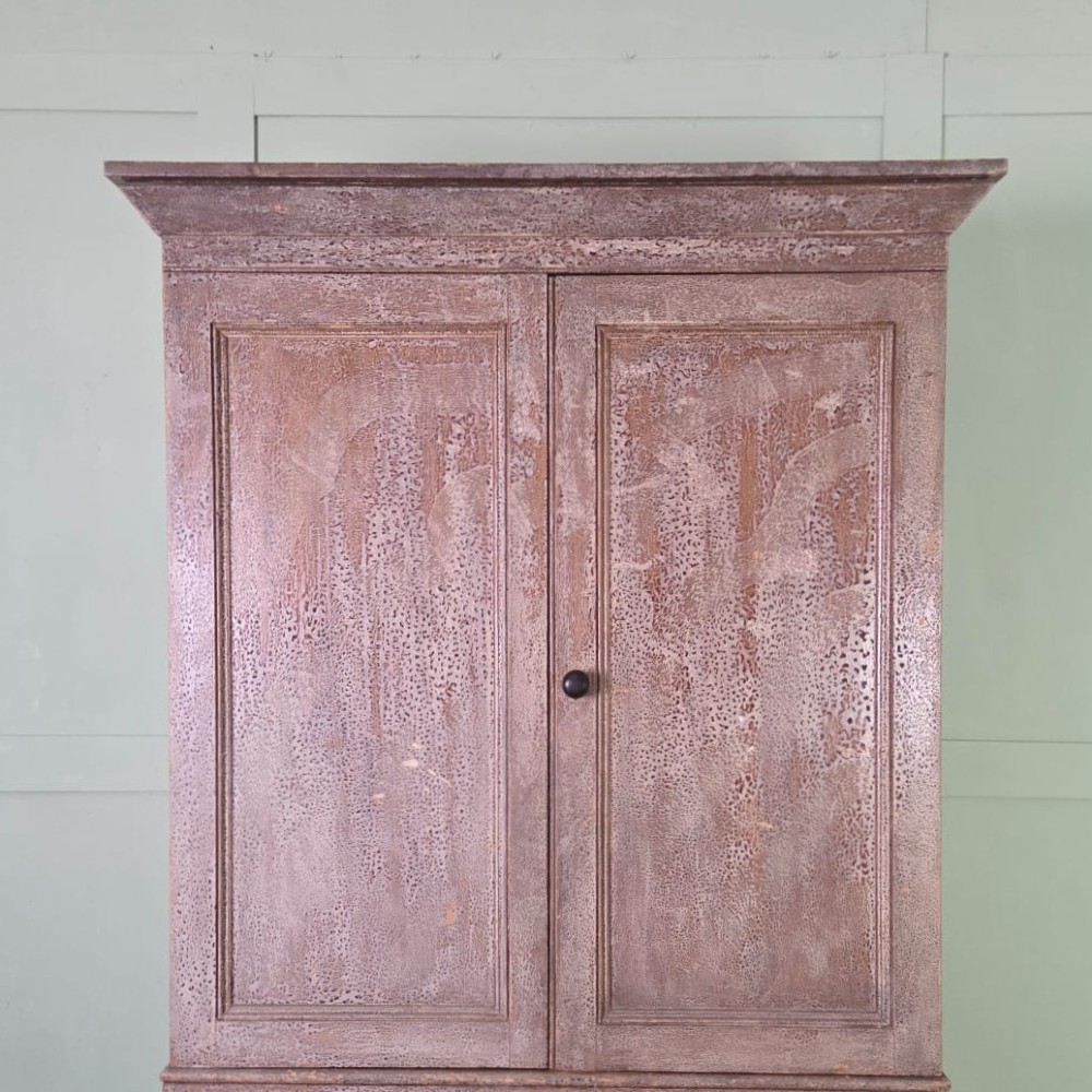 A tall late Georgian painted pine housekeepers cupboard featuring panelled upper doors and three lower drawers on turned feet. View XII