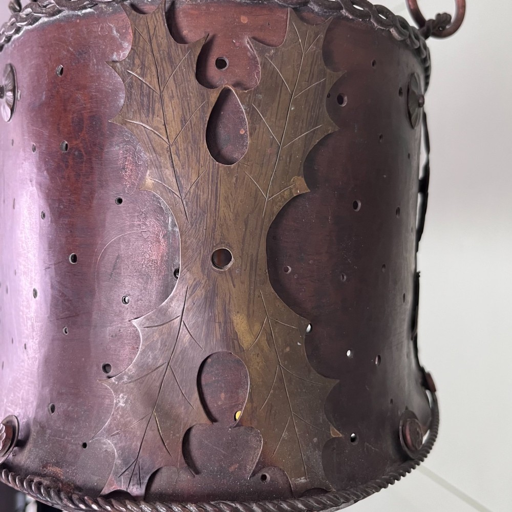 An oval Arts and Crafts copper pendant light featuring hand-chased floral motifs suspended from twin copper link chains with ceiling roses. View XI