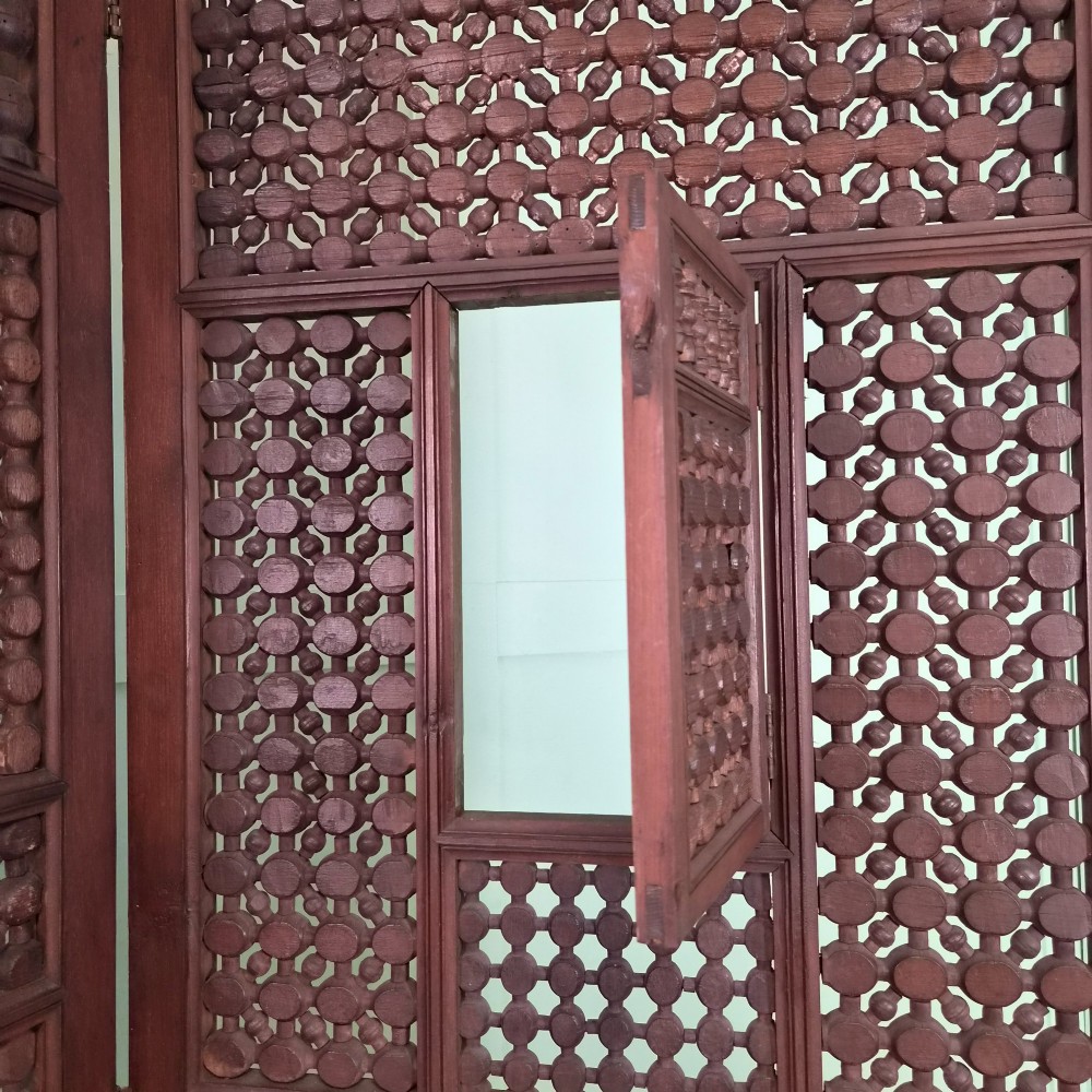 A three-panel antique wooden folding screen featuring intricate turned spindle lattice work and geometric carved panels in a dark brown finish. View IX