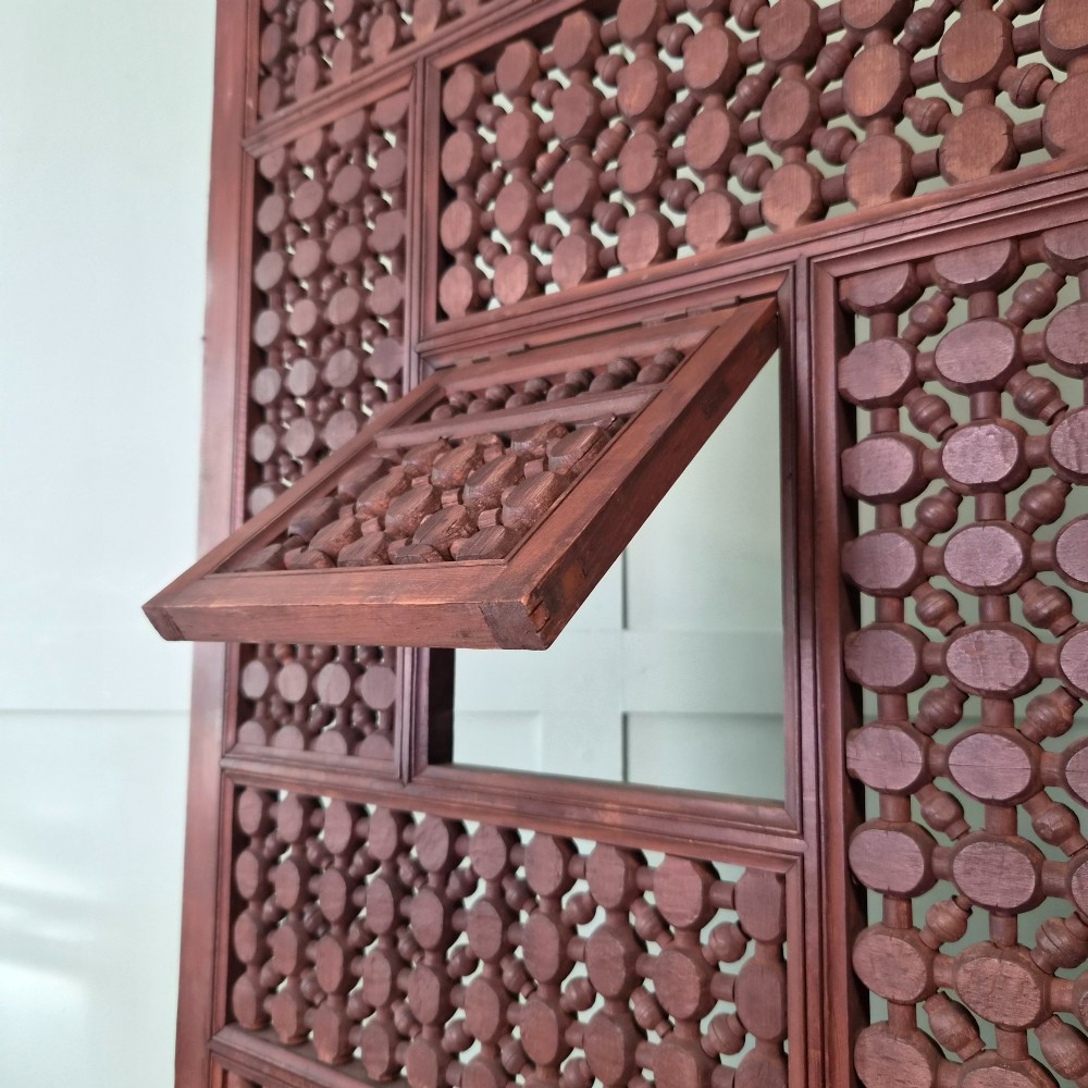A three-panel antique wooden folding screen featuring intricate turned spindle lattice work and geometric carved panels in a dark brown finish. View X
