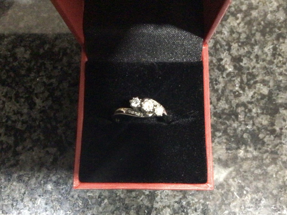 A platinum diamond crossover ring featuring three claw-set round diamonds set on a twisted platinum band. View V