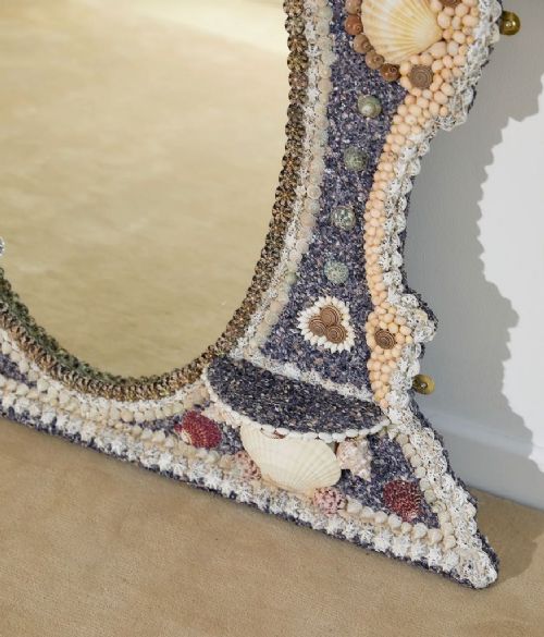 An architectural Georgian wall mirror frame encrusted with natural cream shells and dark blue mineral accents surrounding a central oval glass plate. View IV