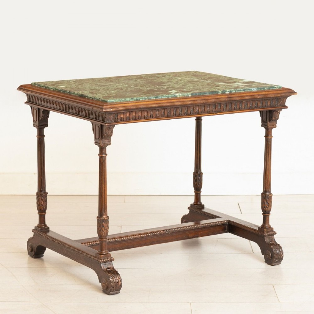 A 19th-century rectangular mahogany side table featuring a carved fluted apron, turned legs with an H-stretcher, and an inset green marble top.