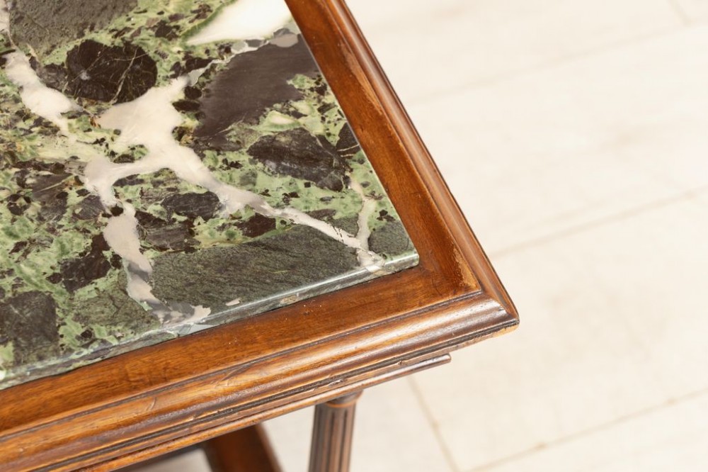 A 19th-century rectangular mahogany side table featuring a carved fluted apron, turned legs with an H-stretcher, and an inset green marble top. View IV