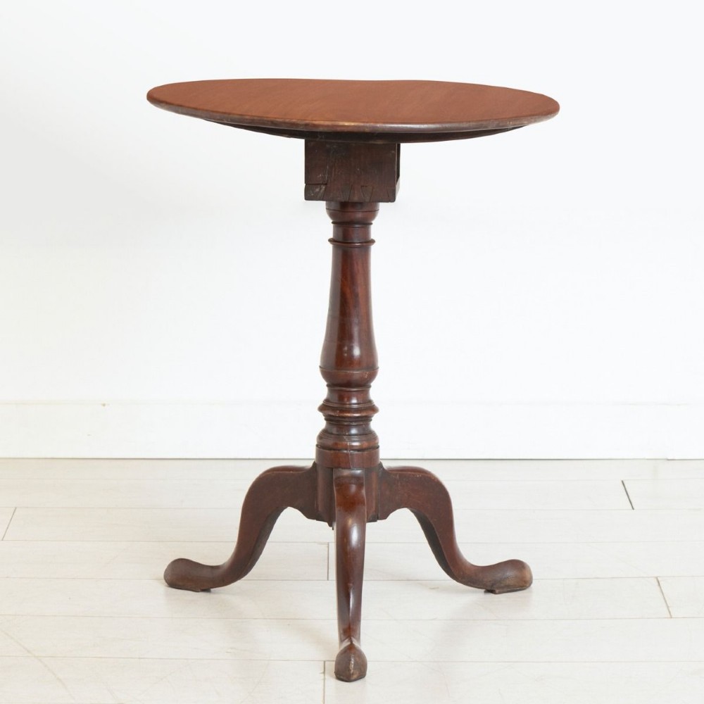 An 18th-century Georgian mahogany side table featuring a circular tilt top, a square birdcage mechanism, a turned central stem, and three cabriole tripod legs with pad feet.
