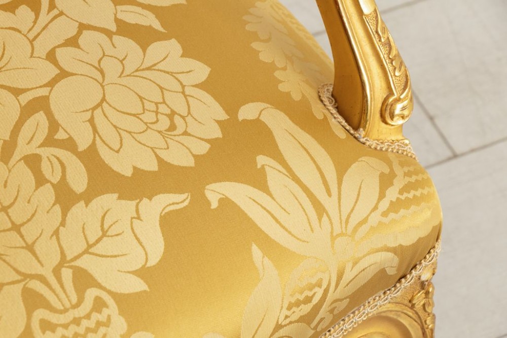 A pair of carved French Rococo giltwood armchairs upholstered in yellow silk floral damask fabric. View IV