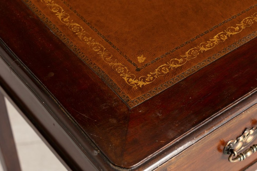 An Edwardian mahogany ladies writing desk featuring a brown leather inlaid top, three frieze drawers with brass handles, and slender cabriole legs. View IV
