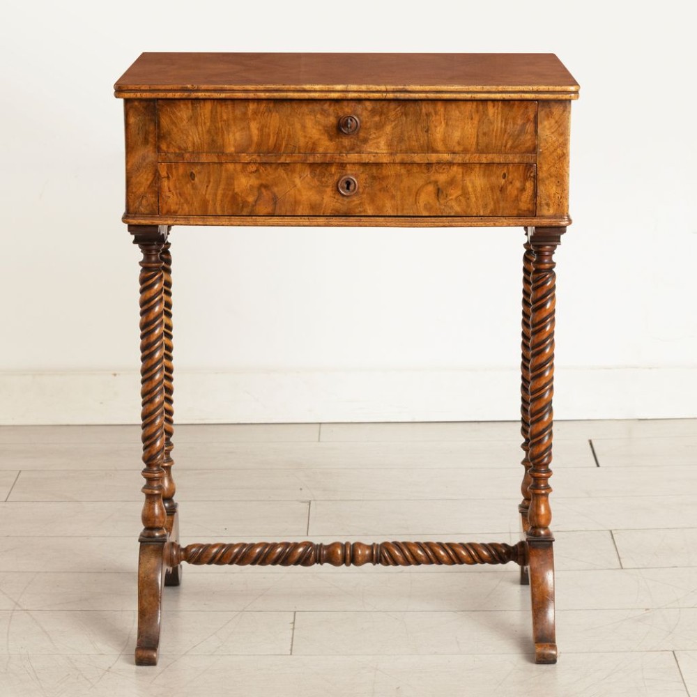 An antique burr walnut sewing table with two drawers, four turned barley twist legs, keyhole details, and a central stretcher base. View II