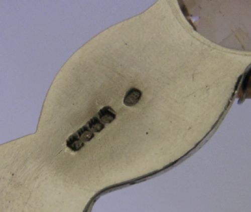 A Scottish sterling silver letter opener featuring Celtic interlace carving and an amber-toned citrine gem on the handle. View VII
