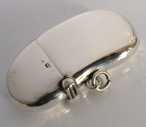 An Edwardian sterling silver kidney bean shaped vesta case featuring a hinged lid and suspension ring. View II