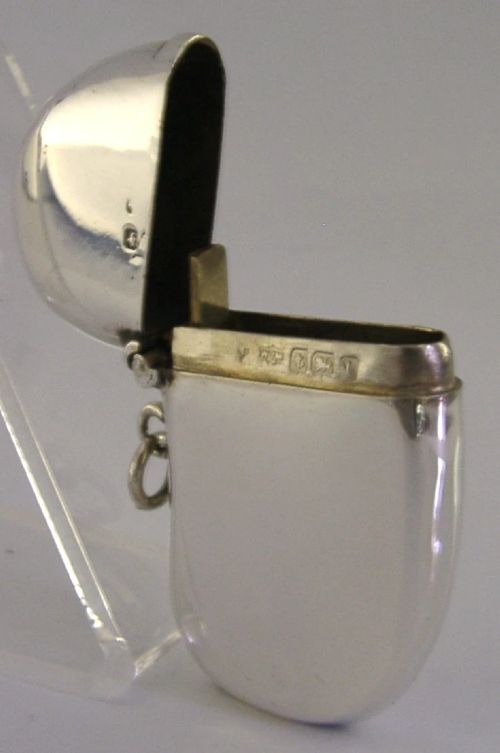 An Edwardian sterling silver kidney bean shaped vesta case featuring a hinged lid and suspension ring. View IV