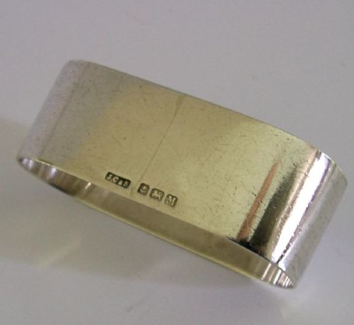 A flat sterling silver napkin ring featuring a central oval faceted citrine gemstone framed by a radiant engraved sunburst motif. View V