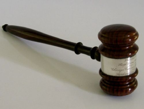 A turned dark hardwood gavel featuring a central sterling silver collar with engraved presentation text. View IV