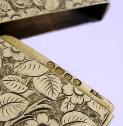A Victorian shield-shaped sterling silver vesta case engraved with floral motifs and a central vacant cartouche. View VII