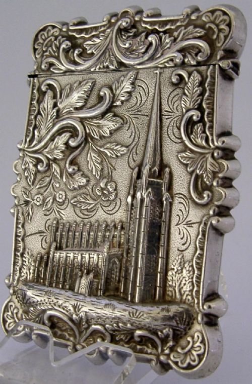 A mid-19th-century sterling silver card case featuring an embossed architectural depiction of Trinity Church surrounded by foliate scrollwork. View VI
