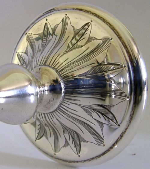 A mid-Victorian sterling silver chalice featuring an engraved scroll pattern around the cup, a central knopped stem, and a leaf-patterned circular base. View V