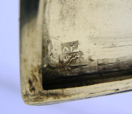A rectangular solid silver cigarette case featuring hand-chased relief work depicting birds and floral motifs surrounded by a decorative border. View VII
