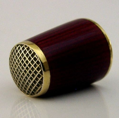 A mid-century Norwegian sterling silver thimble featuring rich red translucent guilloche enamel and a gilded waffle-patterned top. View II