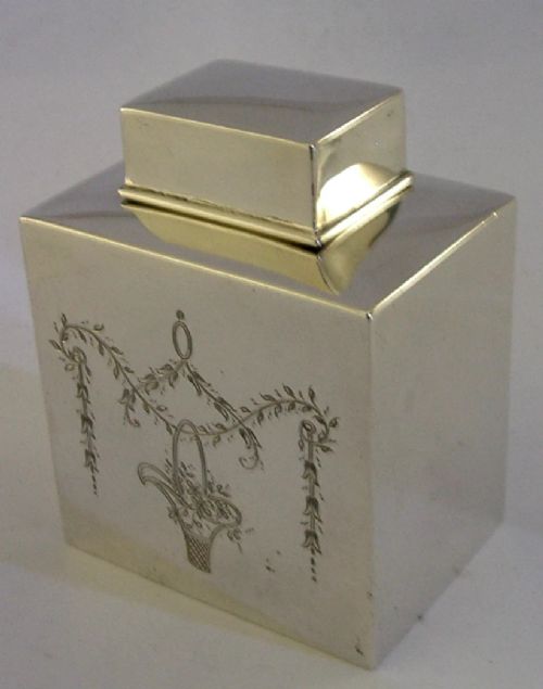 An antique Edwardian rectangular sterling silver tea caddy decorated with delicate engraved floral swags and a central flower basket, topped with a square cap lid. View III