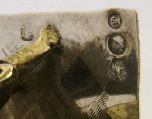 An 833 solid silver miniature model depicting a Punch and Judy puppet show booth with figures, an organ grinder, and a dog on a flat silver base. View VIII