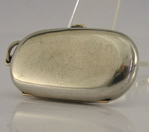 An open Edwardian sterling silver double sovereign case with gold hinge detail showing two spring-loaded coin compartments. View VII