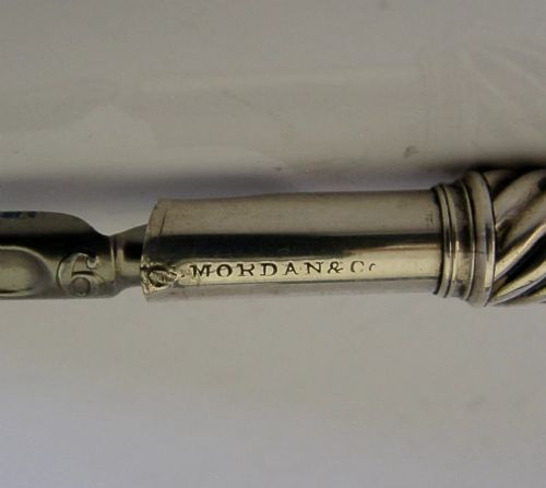 A Victorian sterling silver dip pen featuring a spiral fluted barrel and a metal writing nib. View IX