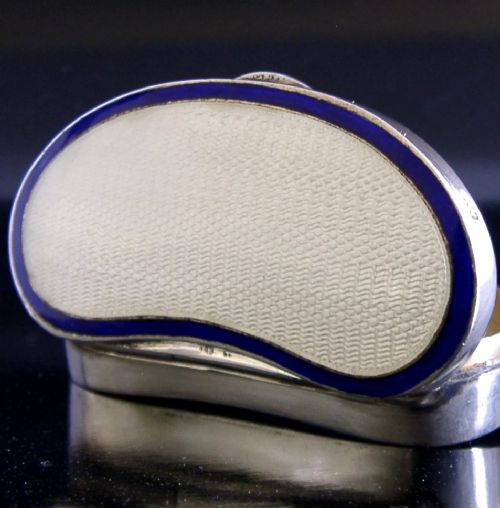 An Edwardian kidney-shaped sterling silver box featuring a white guilloche enamelled lid bordered with deep royal blue enamel. View II