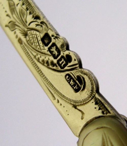 An Edwardian folding fruit knife with a carved mother-of-pearl handle and engraved silver shield cartouche. View IX
