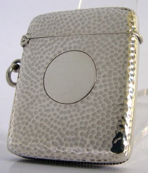 An Edwardian sterling silver pocket vesta case featuring a planished hammered surface and a central unengraved circular cartouche. View III
