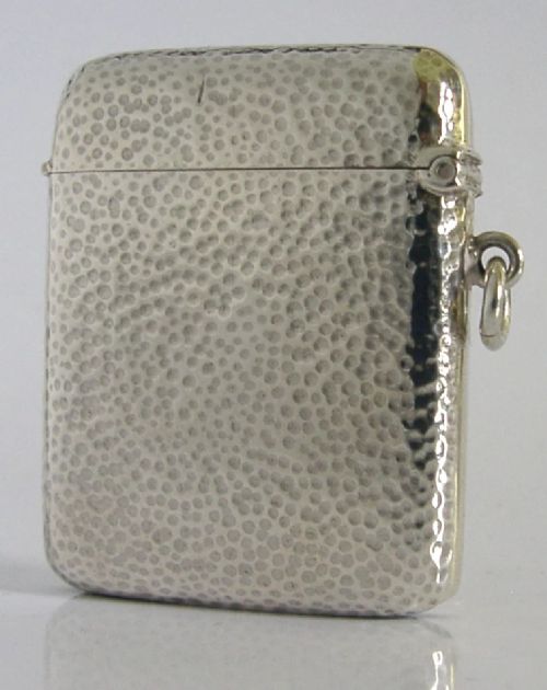 An Edwardian sterling silver pocket vesta case featuring a planished hammered surface and a central unengraved circular cartouche. View IV