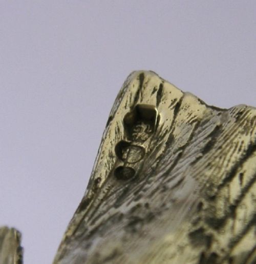 A solid silver pepper pot finely chased in the detailed form of a bird chick with outstretched wings. View XIII