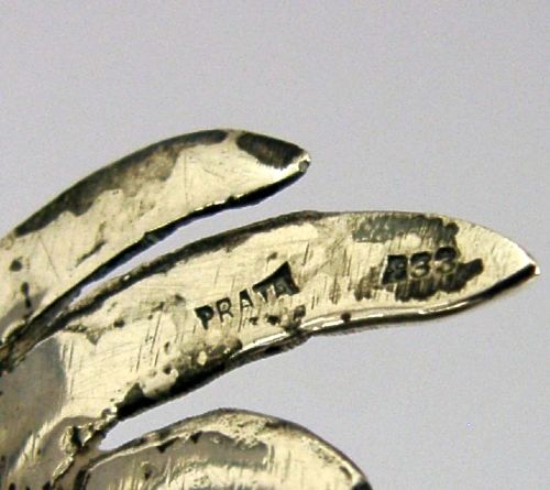 A solid silver figurine of a cockerel standing with open tail feathers and detailed feather chasing. View IX